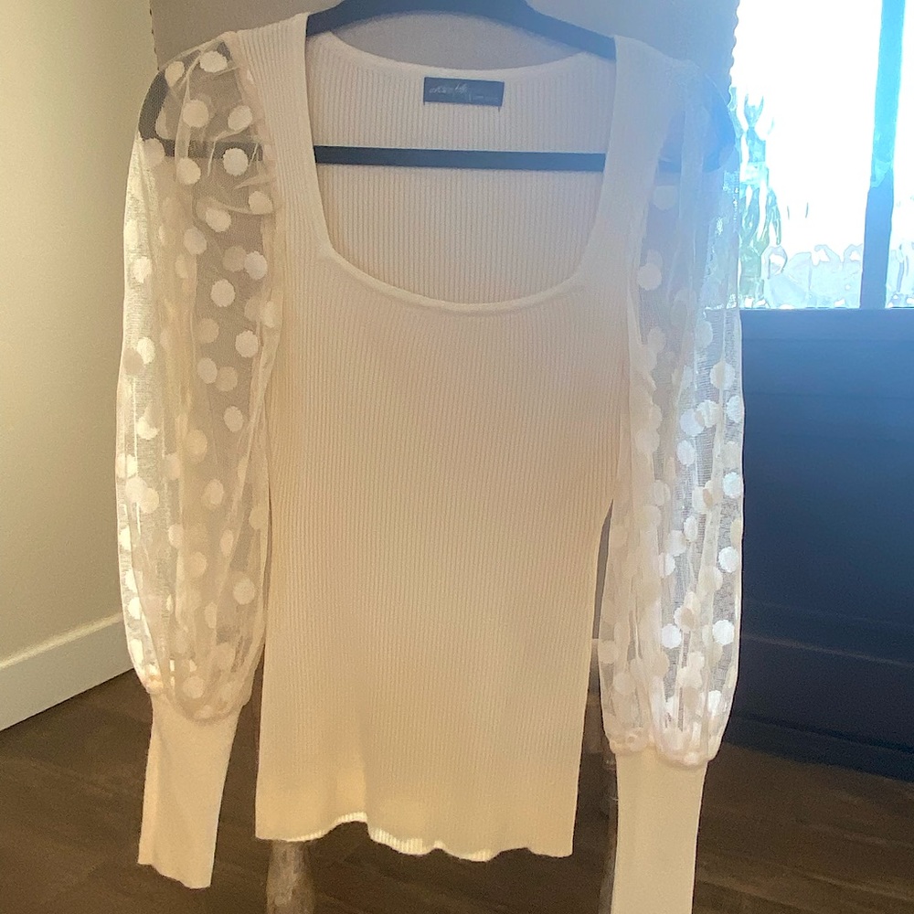 Never worn! Beautiful cream sweater with see through polkadots sleeves. Size S